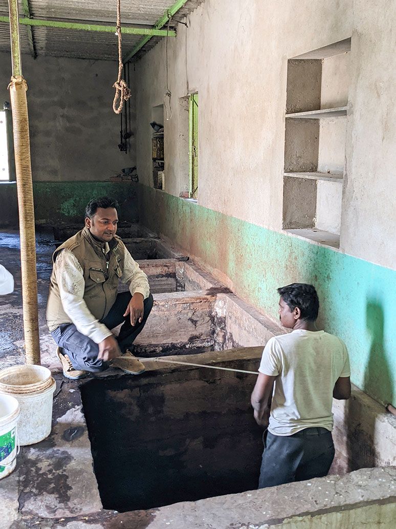 Artisans taking measurement of individual tanning pits for total volume estimation